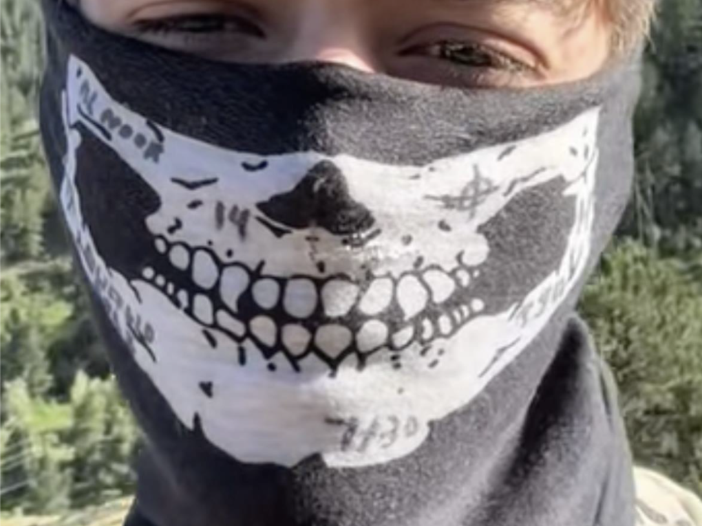 A photo of Desmond Holly in a skull mask.
